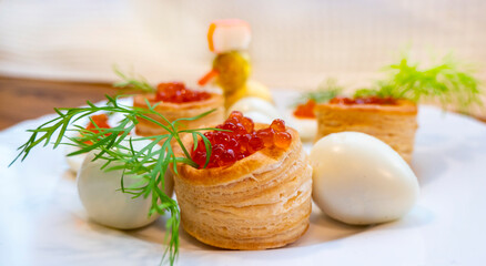 Closeup of caviar and cream cheese appetizer on crackers