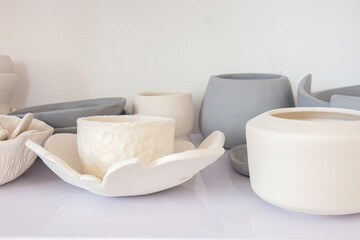 Ceramic crockery and craft pottery cups. Handicraft clay earthenware bowls in artisan craftsman classes workshop . Pottery, different pottery