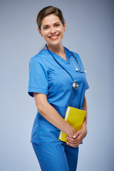 Woman student of nurse profession in medical suit with yellow book. Isolated portrait.