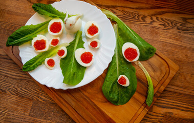 background of red caviar on dsrk wooden surface. tartlets with red caviar