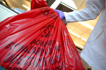 Hazardous waste bag being collected.