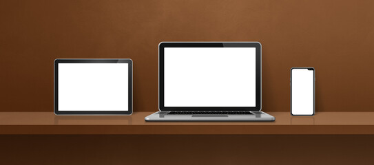 Laptop, mobile phone and digital tablet pc on brown wall shelf. Banner background