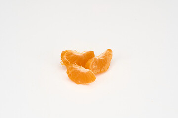 peeled tangerine slices on a white