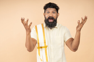 Amazed or shocked South indian man with open mouth and astonished expression and open arms isolated...
