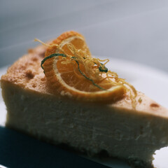 Orange cheesecake with zest of orange by window light
