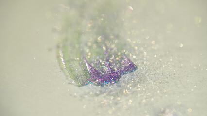 Close up view of shiny purple glitter on white background