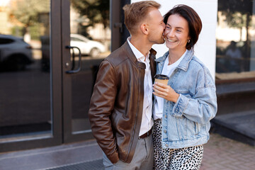 a couple of 30 years old with coffee to go for walks