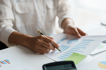 Close-up of businesswoman hands working and pointing to a chart expenses, manage budget, income...