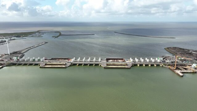 Afsluitdijk construction on pumping stations new sluices and the A7 near Den Oever, Kornwerderzand , and Zurich. Lock for shipping, road traffic cyclists and walkers. Aerial drone view.