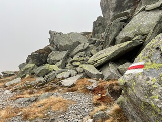 Mountaineering signposts and markings in the mountainous area of the alpine St. Gotthard Pass...