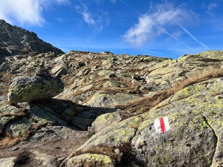 Mountaineering signposts and markings in the mountainous area of the alpine St. Gotthard Pass (Gotthardpass) and the massif of the Swiss Alps, Airolo - Canton of Ticino (Tessin), Switzerland (Schweiz)