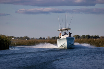 Speeding center-console fishing boat.