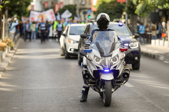 Romanian policeman on BMW police motorcycle at a protest.