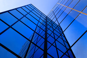 Business Building with Glass Windows Reflecting Blue Sky