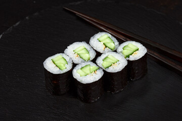 Sushi Maki rolls cucumber. Fresh hosomaki pieces with rice and nori. Close Up of delicious japanese food with sushi roll.