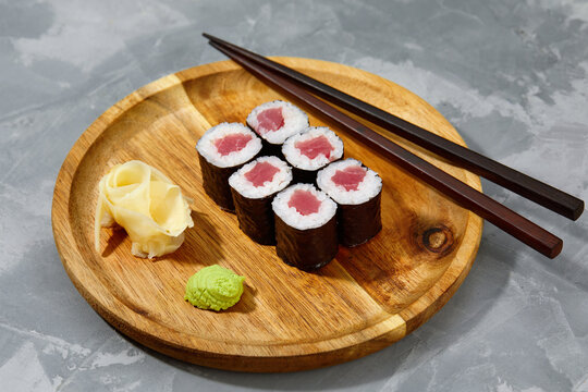 Set Of Tuna Sushi Rolls On Black Desk Background