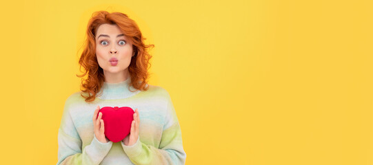 Woman isolated face portrait, banner with copy space. funny redhead woman with red heart on yellow background. valentines love day.