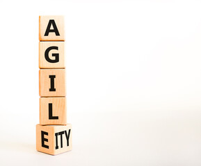 Agile and agility symbol. Concept words Agile and Agility on wooden cubes. Beautiful white table white background. Business agile and agility concept. Copy space.