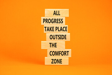 Progress symbol. Concept words All progress take place outside the comfort zone on wooden blocks on a beautiful orange table orange background. Business motivational and progress concept.
