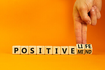Positive mind and life symbol. Concept words Positive mind or Positive life on wooden cubes. Businessman hand. Beautiful orange table orange background. Business positive mind life concept. Copy space