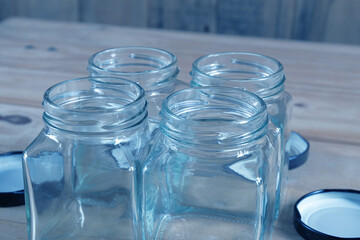 Empty Jam jar bottles on wood table background.