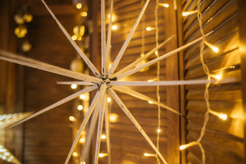 new year, christmas decor, golden stars with luminous garlands on a wooden background. High quality photo