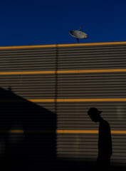 A Turned off Antenna against a Dark Blue Sky and a Sad Boy Silhouette Walking to a No Reception...