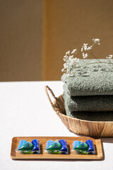 laundry cleaner gel in capsules and towels on background