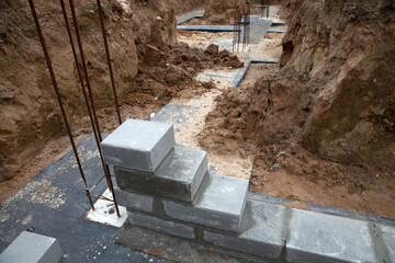 Bricklaying of foundation blocks for a new home. House construction concept