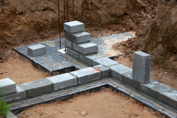 Bricklaying of foundation blocks for a new home. House construction concept