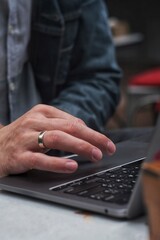 Close up hand of man scrolling a Website Using Laptop Track Pad. Computer keyboard. Using Touchpad Of Laptop.