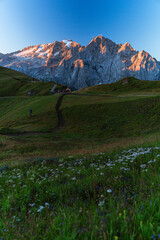 Fototapeta premium View of the Marmolada, the highest peak of the Dolomites, with its glaciers and the morning light, near the town of Canazei, Italy - August 2022.