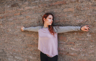 woman holding on to stone wall frontal photo