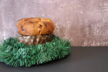 Panettone with Christmas decoration and brown background