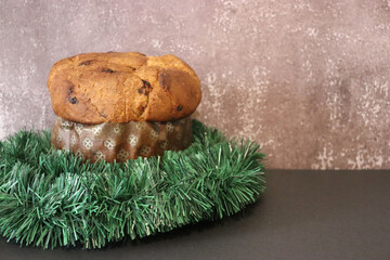 Panettone with Christmas decoration and brown background