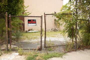 No Trespassing sign with old chain link fence