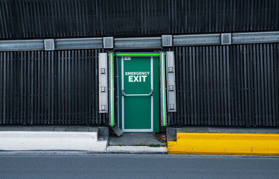 Emergency Exit Sign In An Underpass Highway Tunnel Road. Transportation Industry.