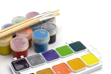 Paints for drawing on a white background. Paint brushes