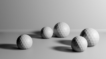 Group of low poly polygonal balls or spheres in realistic 3D studio interior, abstract monochrome background with copy space for text