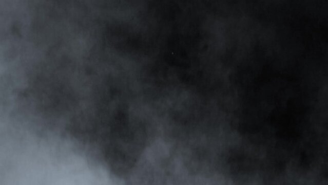 Abstract white smoke in slow motion. Smoke, Cloud of cold fog in light spot background. Light, white, fog, cloud, black background, 4k, ice smoke cloud. Floating fog.	