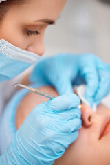 woman during a mechanical face cleansing procedure