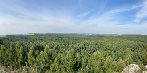 Obraz premium Summer day blue sky mountains landscape. Nature landscape with sun and blue sky. Summer travel in Europe mountains. Nature, lake, forest, trees hiking path. Clouds on blue sky. Forest landscape hiking