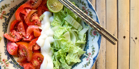 bowl of vegetable salad with chinese cabbage, tomato with mayonnaise dressing 