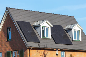 Solar panels installed on the tiled roof of a new house