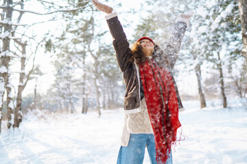 Portrait of young beautiful woman in the winter forest. Christmas, winter holidays concept.