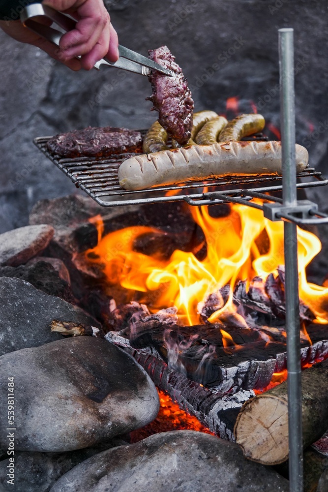 Poster Vertical of barbecue and sausages being grilled outside