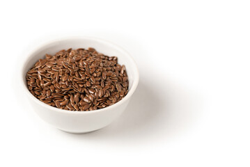 Raw flax seeds in ceramic bowl on white background for Superfood and diet product concept