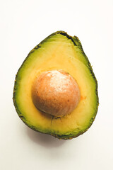 Close-up photo of a cut avocado on a white background.