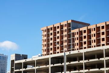 Unfinished tall buildings against the blue sky