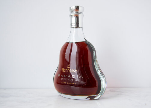 MOSCOW, RUSSIA - DECEMBER 10, 2018: Bottle of Hennessy Paradis Extra Rare Cognac on White Wall Background. Product of France. Toned